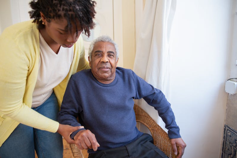 Senior volunteer visiting another senior at home
