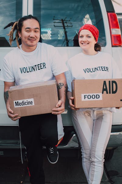 Volunteers carrying donation boxes at an event